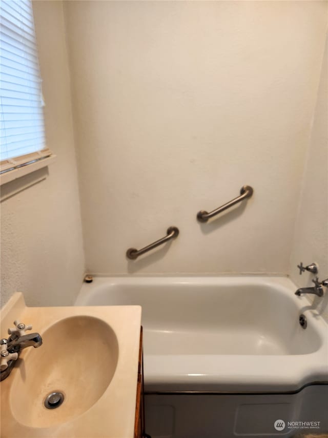 bathroom with a bathtub and vanity