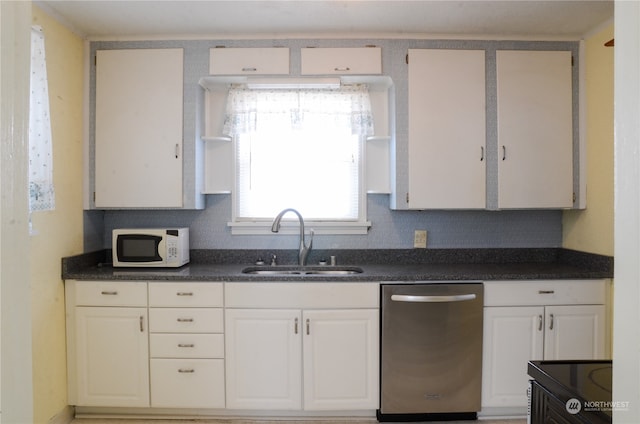 kitchen with dishwasher, white cabinets, and sink