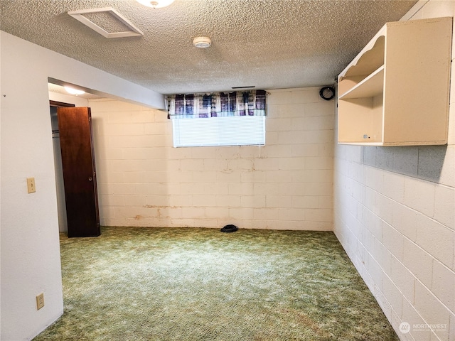 basement featuring a textured ceiling and carpet floors