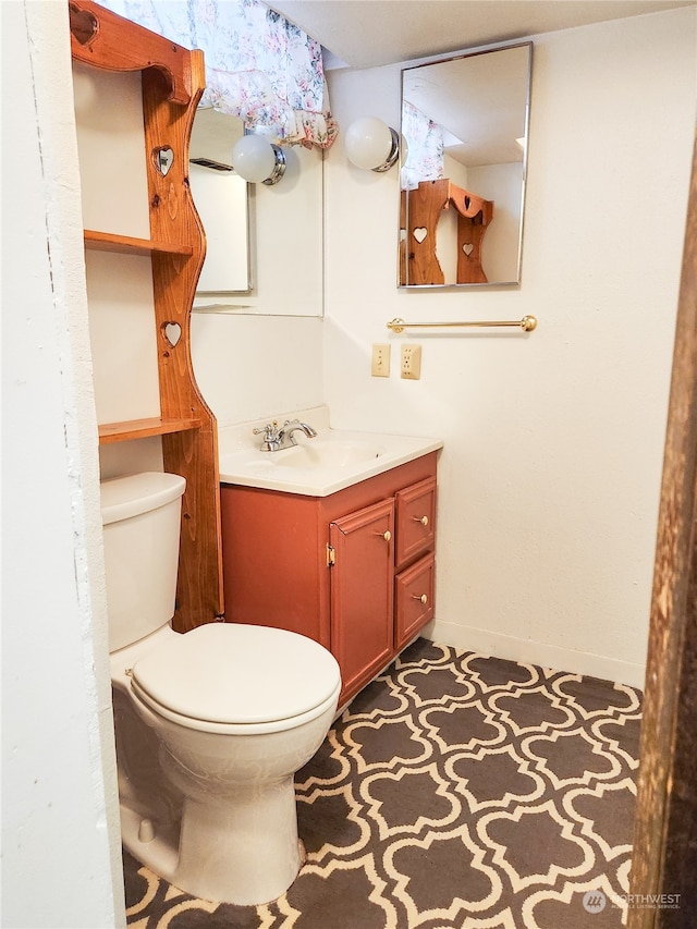 bathroom featuring vanity and toilet