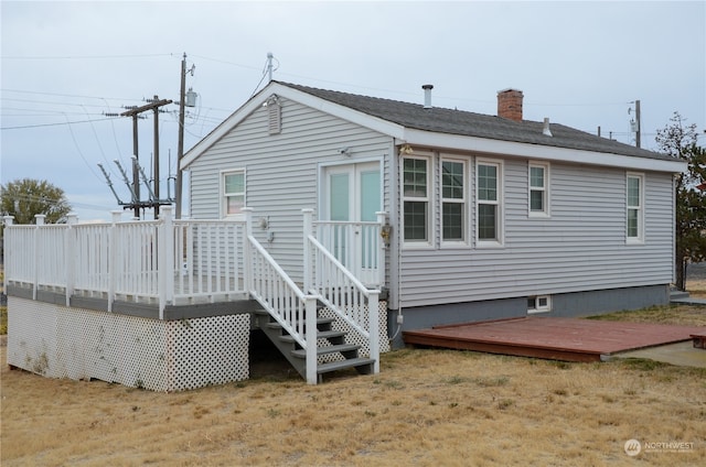 rear view of house featuring a wooden deck