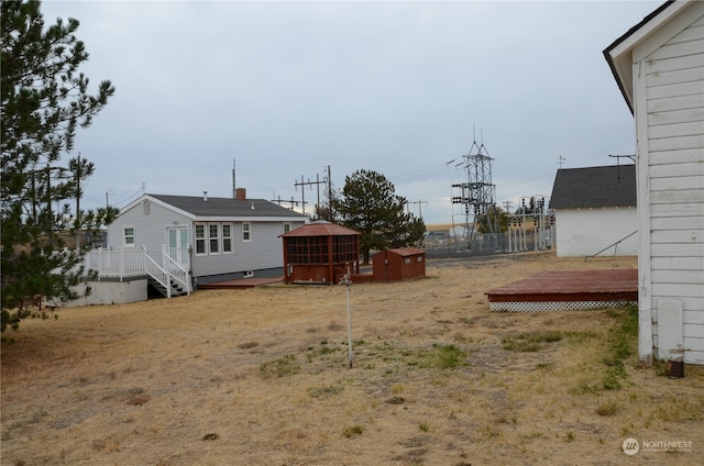 view of yard featuring a storage shed and a deck