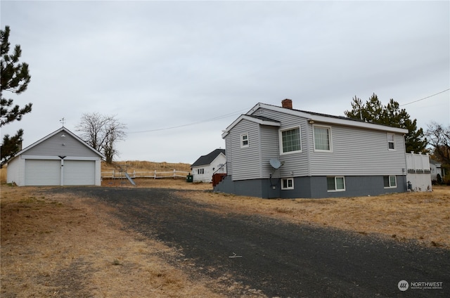 view of property exterior featuring a garage and an outdoor structure