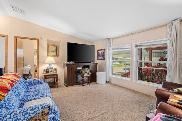 carpeted living room with vaulted ceiling