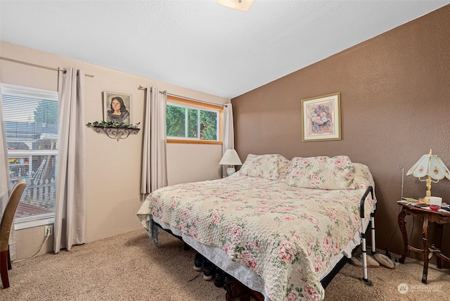 carpeted bedroom with vaulted ceiling