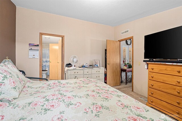 carpeted bedroom featuring a textured ceiling