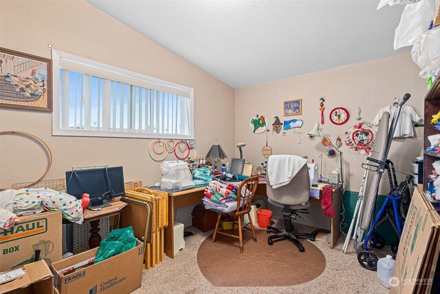 home office with vaulted ceiling and carpet