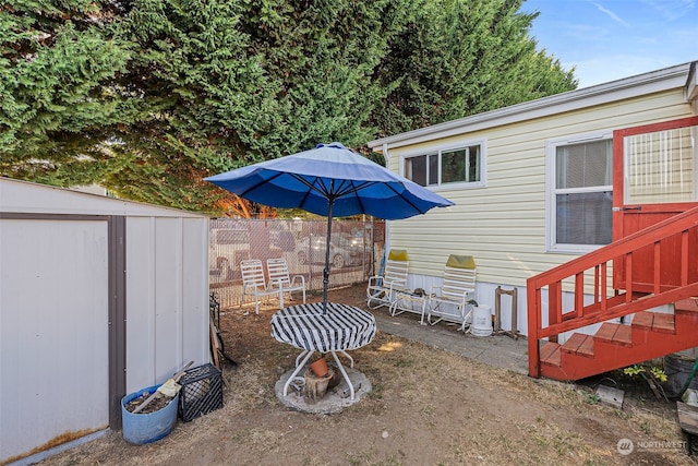 view of yard featuring a storage shed and a patio