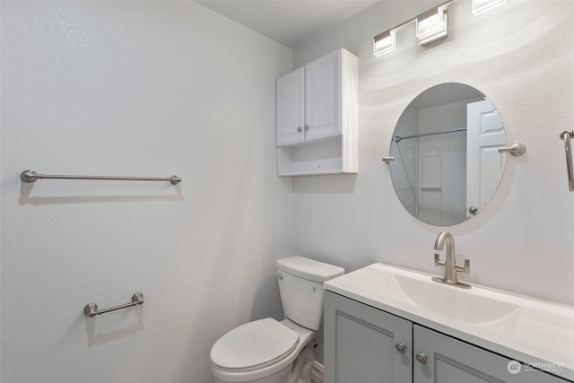 bathroom with vanity, toilet, and walk in shower