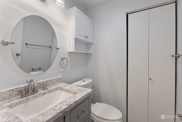 bathroom featuring vanity and toilet