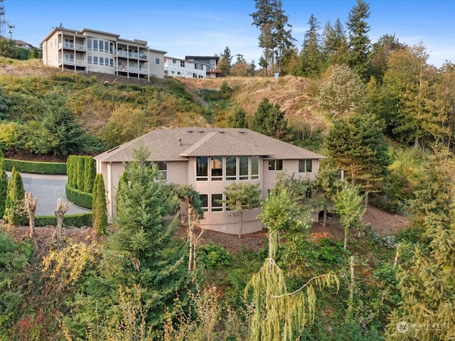 back of property with a balcony