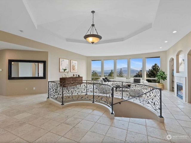 interior space featuring a mountain view and a raised ceiling