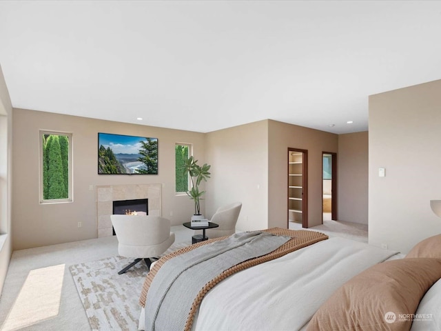 carpeted bedroom featuring a fireplace