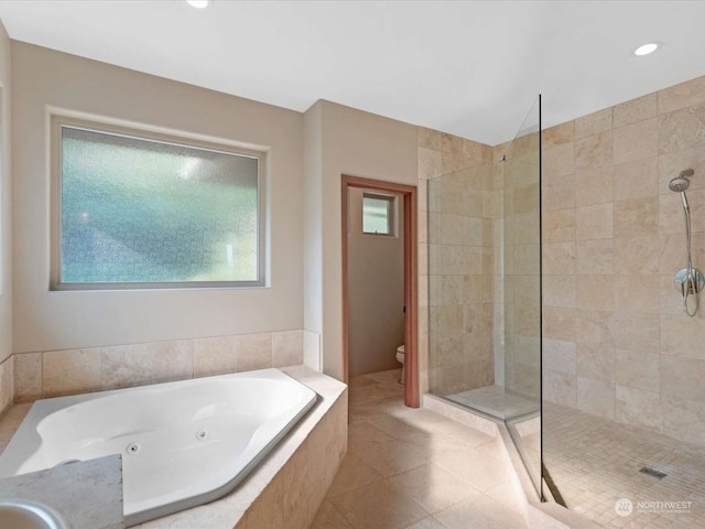 bathroom featuring tile patterned flooring, toilet, and plus walk in shower