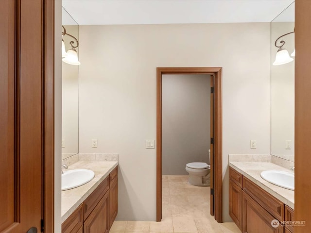 bathroom featuring vanity, toilet, and tile patterned floors