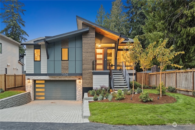 contemporary house with a garage and a front lawn