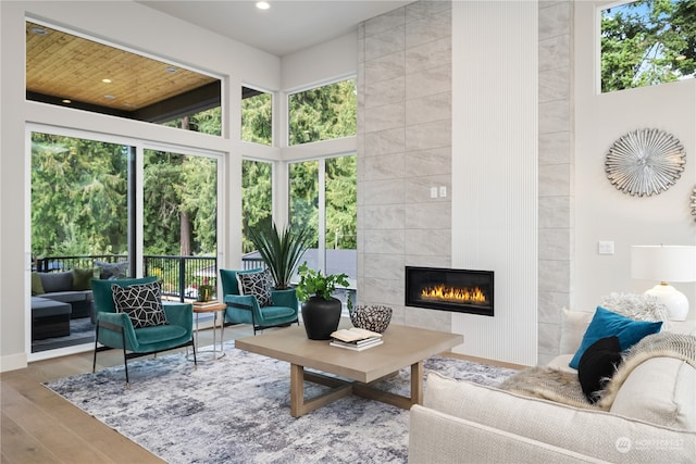 living room featuring hardwood / wood-style floors and a tile fireplace