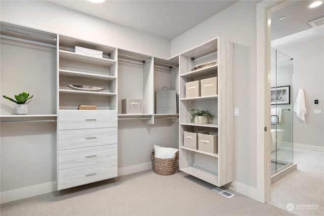 walk in closet featuring carpet