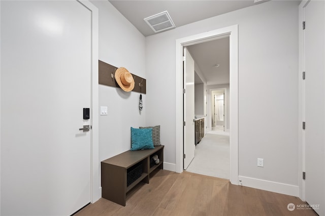 mudroom with light hardwood / wood-style floors