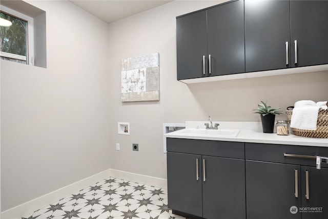 clothes washing area with cabinets, sink, electric dryer hookup, and washer hookup