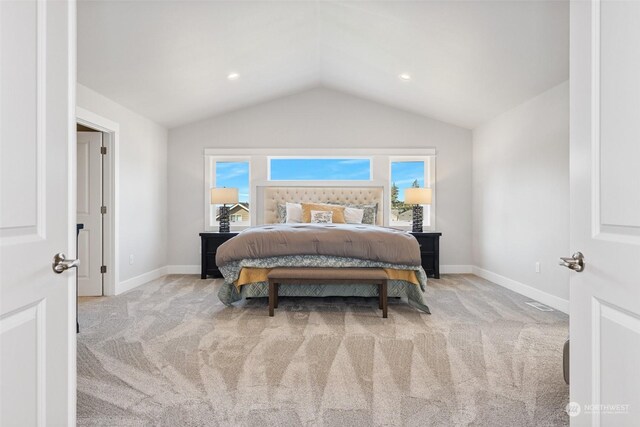 bedroom featuring lofted ceiling and light carpet