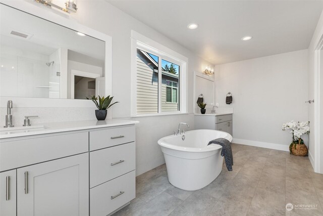 bathroom with vanity and separate shower and tub