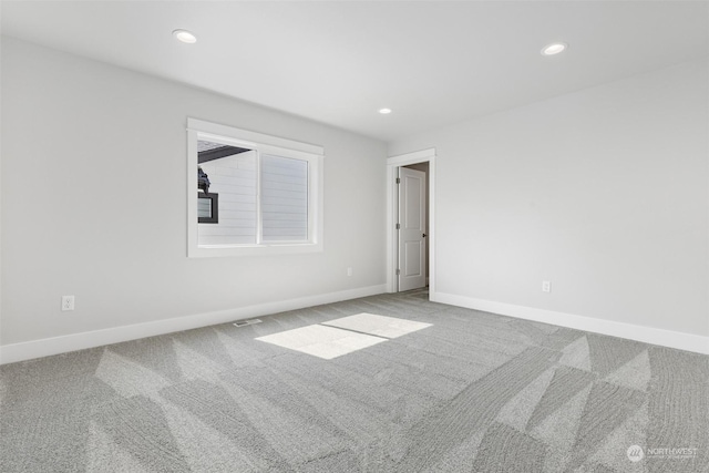 spare room with carpet flooring, recessed lighting, and baseboards