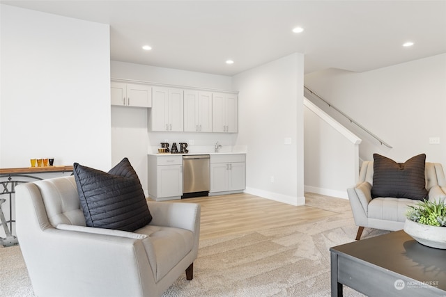 living room with sink and light hardwood / wood-style floors