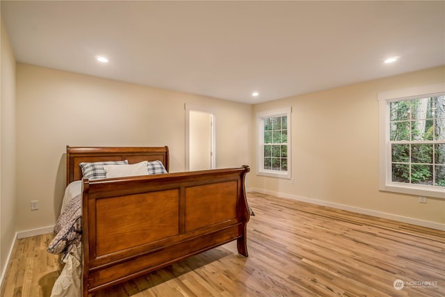 bedroom featuring light wood-type flooring and multiple windows