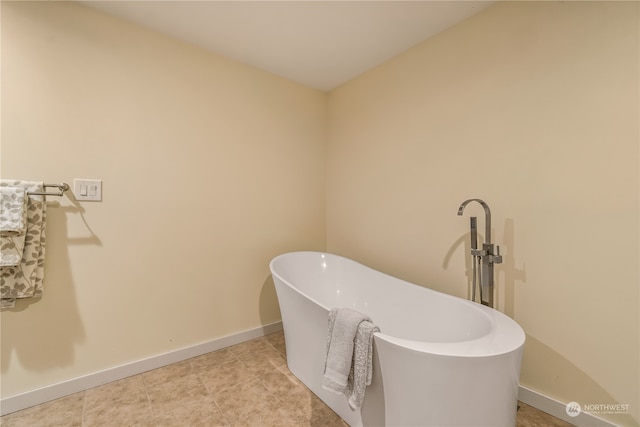 bathroom featuring tile patterned flooring and a washtub