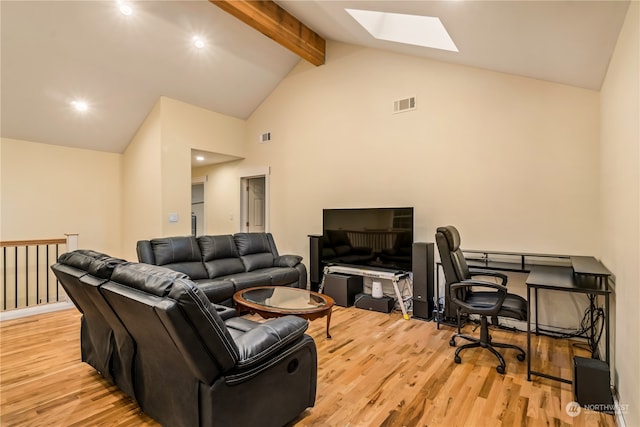 living room featuring light wood-type flooring, beam ceiling, a skylight, and high vaulted ceiling