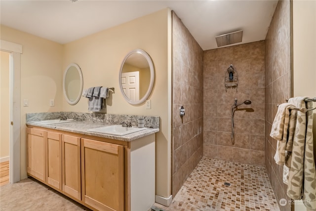 bathroom featuring vanity and a tile shower