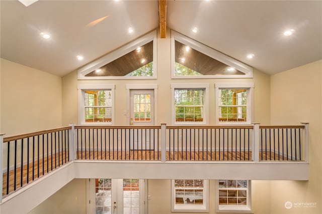 hallway featuring french doors, beam ceiling, and high vaulted ceiling