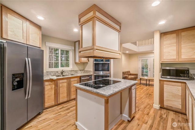 kitchen featuring light wood-type flooring, sink, light brown cabinets, and stainless steel appliances