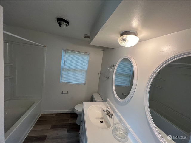 full bathroom with toilet, hardwood / wood-style flooring, bathing tub / shower combination, and vanity