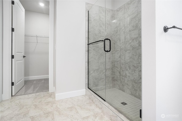 bathroom featuring a shower with shower door