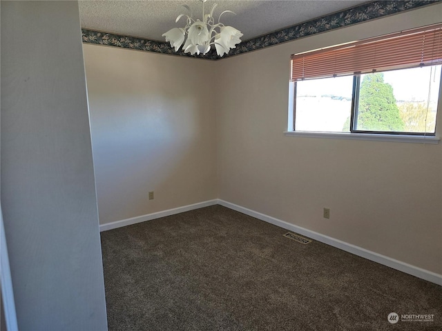 empty room featuring carpet, baseboards, visible vents, a textured ceiling, and a notable chandelier