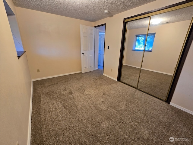 unfurnished bedroom with a closet, a textured ceiling, and carpet floors