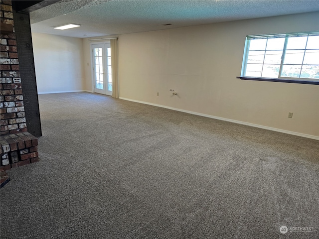 unfurnished living room with a textured ceiling and carpet floors