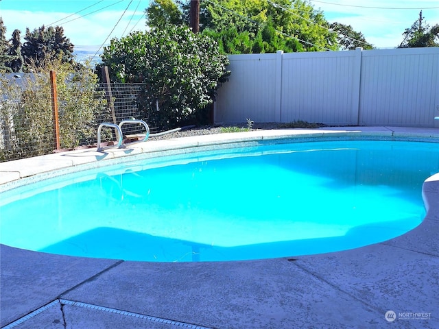 view of swimming pool with a fenced in pool and a fenced backyard