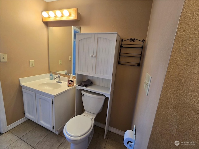 bathroom with tile patterned floors, toilet, vanity, and baseboards