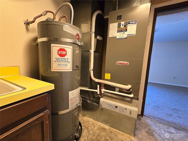 utility room featuring water heater