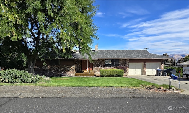 single story home with a garage and a front lawn