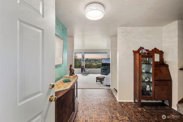 hallway featuring a textured ceiling