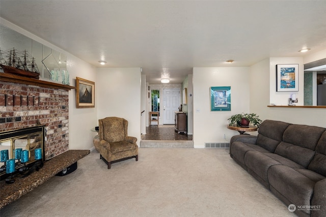 carpeted living room featuring a fireplace