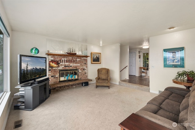 living room with carpet and a brick fireplace