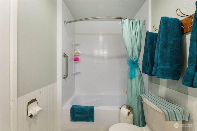 bathroom with toilet and shower / bath combo with shower curtain