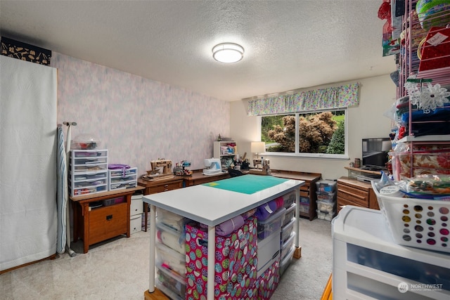 carpeted home office featuring a textured ceiling