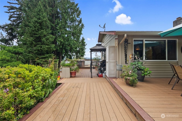 wooden terrace featuring a gazebo