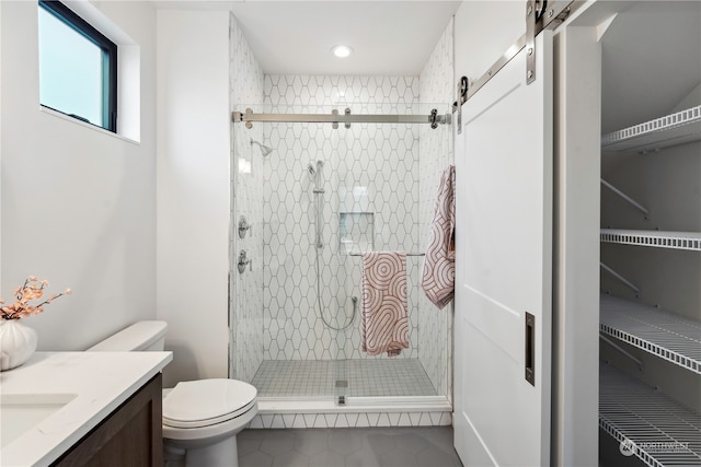 bathroom with vanity, toilet, tile patterned floors, and a shower with door